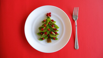 Funny edible Christmas and New Year tree idea for kids on red background top view