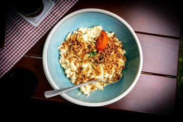 A German specialty - Allgaeuer Kaesespaetzle with onions and tomato