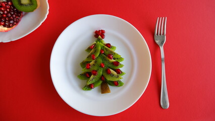 Funny edible Christmas and New Year tree idea for kids on red background top view