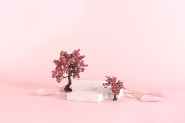 Spring gentle mockup with three white podiums for showing cosmetic product with sakura tree, flower...