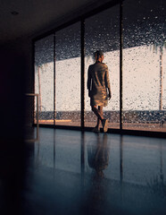 Blonde woman in sweater dress looking outside walks past a sliding glass door with raindrops. 3D render.