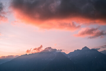 Fototapeta na wymiar Pink clouds above the peak of Pizzo Redorta during sunset in the Orobie Alps, Northern Italy