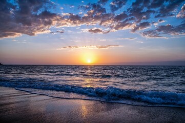 Fototapeta premium Scenic shot of an empty sandy beach at sunset