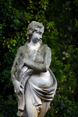 Classical ancient statue of a woman in a backyard garden in summer. Suburb of Venice. Italy