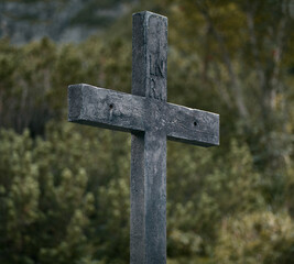A wooden cross in the mountains on a tourist track.