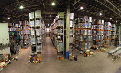 Huge distribution warehouse with high shelves and forklift.