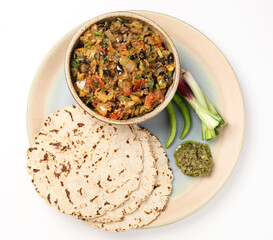 indian village food, Jowar Roti or Indian bread, served with roasted eggplant/brinjal curry ,green chilli thecha OR Chutney