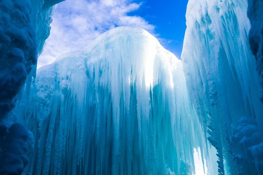 Beautiful view of huge ice formations against the blue sky with floating white clouds