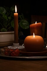 Vertical shot of candles with different shapes placed on a table