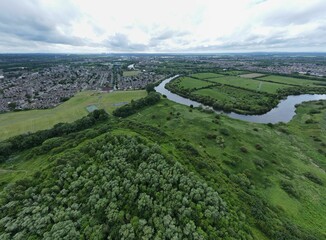 Aerial view of a meander of the River Mersey in Warrington, Cheshire with Paddington Meadows behind
