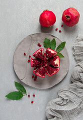 Fresh, cut pomegranate fruit, on a gray background, food concept, top view, no people,