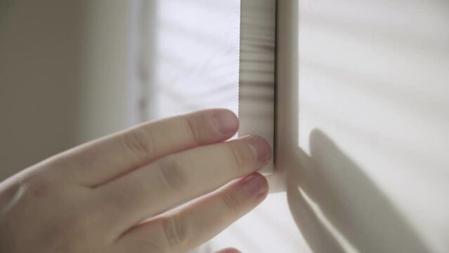 Hands fix a picture on the wall