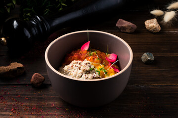 Quinoa porridge with coconut milk in bowl wooden rustic background. Healthy Lactose and Gluten Free Breakfast