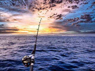 fishing rod and reel anchored to the ship looking for a big catching in a deep seascape offshore