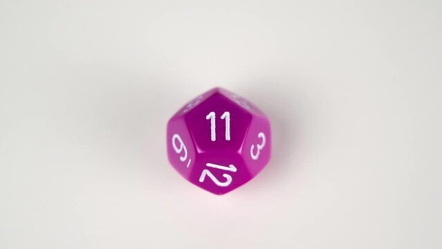 Stop frame animation of a purple D12 Percentile gaming die used for table top role playing games
