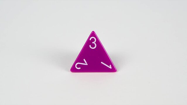 Stop frame animation of a purple D4 gaming die used for table top role playing games