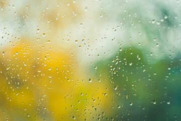 Drops on glass after rain. Autumn weather outside window. Rain outside window.