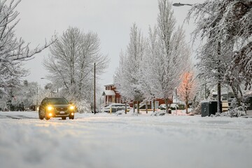 Fototapeta premium Jeep driving on unplowed roads in Albany, Oregon in winter