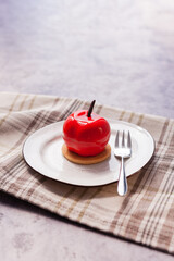 Sweet fresh cake on a plate on a light background