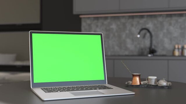 Laptop with blank green screen, standing on table at home. Computer mock up with Chroma Key. Copy space for video, app, game, website presentation. Empty laptop screen. Modern interior. 3D animation