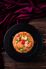 classic italian risotto with shrimps and prawns on a wooden background