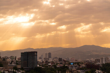 Fototapeta premium Sunset Aerial view of Tbilisi Old Town cityscape with ancient houses, trees and Kura river, Georgia, Europe