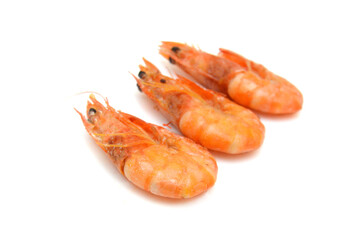 Stack cooked unshelled tiger shrimps isolated on white