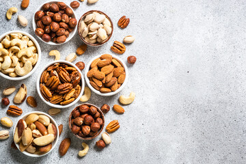 Assortment of nuts in bowls. Cashew, hazelnuts, pecan, almonds, brazilian nuts and pistachios at...