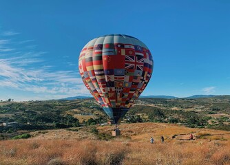 Fototapeta na wymiar Hot air balloon on the ground ready to float in blue sky