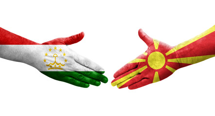 Handshake between Tajikistan and North Macedonia flags painted on hands, isolated transparent image.