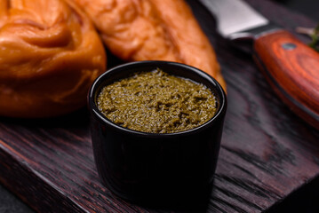 Tasty smoked fillet of chicken breast with spices and herbs on a wooden cutting board