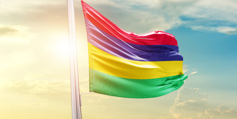 Waving Flag of Mauritius in Blue Sky. The symbol of the state on wavy cotton fabric.