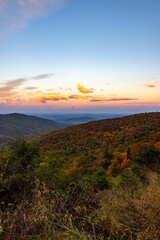 Vertical shot of the Shenandoah National Park with forests and hills under a sunset sky