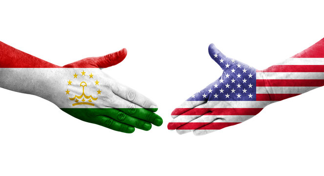 Handshake between Tajikistan and USA flags painted on hands, isolated transparent image.