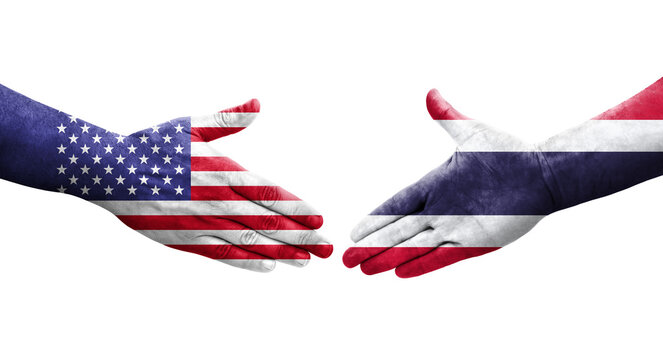 Handshake between Thailand and USA flags painted on hands, isolated transparent image.