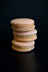 Macarons on black background.Cakes on black background