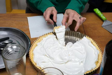 Foto op Canvas Cutting portion of lemon pie with meringue. © arieldufey