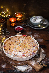 Cranberry, crumble with spices on a wooden and textile background