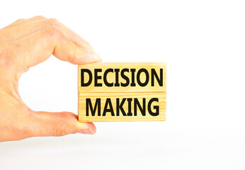 Decision making symbol. Concept words Decision making on wooden blocks. Beautiful white table white background. Businessman hand. Business and decision making concept. Copy space.