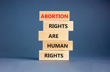 Abortion rights symbol. Concept words Abortion rights are human rights on wooden blocks. Beautiful...
