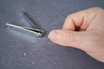 Cut the nails on the hands with nail clippers. Men's manicure. Male hand close up.