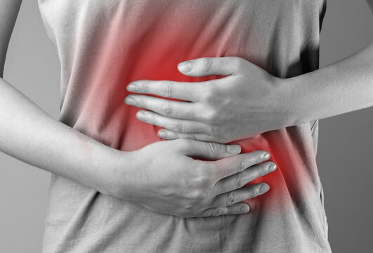 Stomach ache concept. Hands holding belly abdomen suffering from indigestion, gastrointestinal disease, pain, inflammation