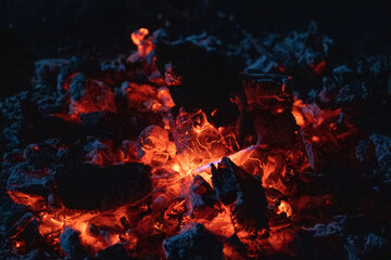 Fototapeta na wymiar Red orange embers of a camp fire