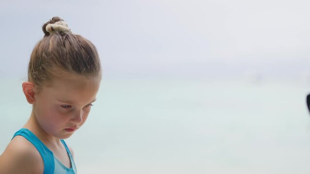 Cute Kid With Sunblock On Beach