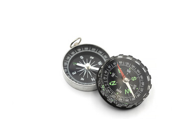 Compass with a black dial isolate on a white background. Traditional navigation device indicating the cardinal points.