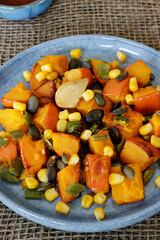 Roasted squash and green poblano pepper vegan salad with pumpkin seeds and corn.