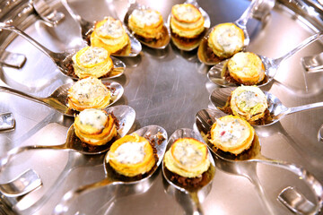 A plate with canapes on spoons. Catering banquet. Table with snacks and canapes at a banquet