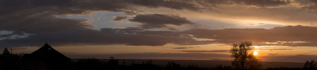 Fototapeta na wymiar Landscape at sunset. Tragic gloomy sky. Panorama. Crimson twilight.