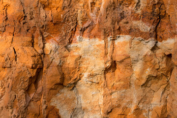 Sedimentary rocks with a high content of iron oxide. Red soil, loam. The texture of the soil.