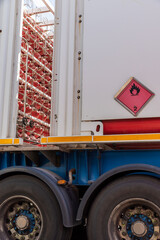 Truck with metal bottles joined by tubes used to transport hydrogen, H2, according to ADR regulations, flammable gas.